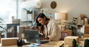 small business owner using laptop home office fintech online invoicing light background